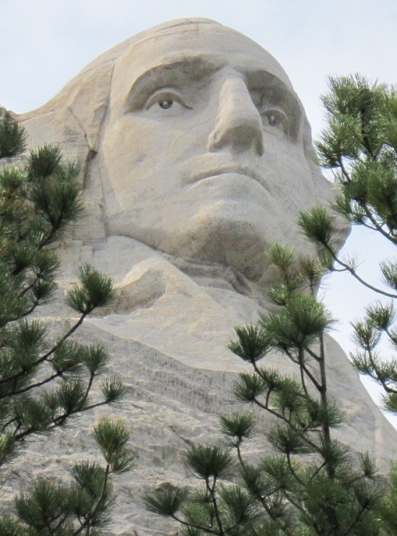 The colossal face of  George Washington as photographed from the Presidential Trail at the Rushmore Memorial. George Washington (1732 - 1799), America's first President is considered the father of the country and is therefore the most prominent figure on the mountain. Photo: Malik Merchant. © Simerg.com