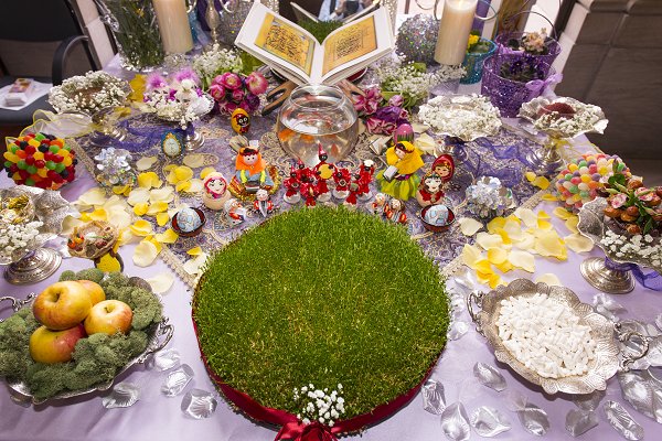 To celebrate the new year, families gather around a specially prepared holiday table to make wishes for the coming months. Items on the haft sin table refer to new life and renewal. Haft sin table at the Freer|Sackler's 2013 Nowruz celebration. Photo by Freer|Sackler staff photographer.