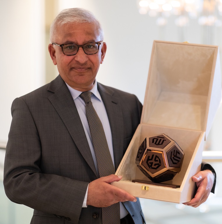 Professor Karim H. Karim holding the first Alumni Recognition Award that was presented to him by the Institute of Ismaili Studies on March 23, 2024, at the Ismaili Centre London. The sculpture was designed by Mohammed Adra (AKDN Geneva) and is inspired by Karl Shlaminger’s Hepta Globe sculpture, which is placed at the entrance of the Aga Khan Centre in London.